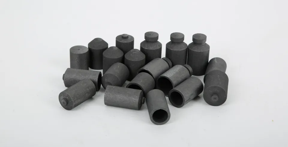 Some graphite crucibles 776-247 are placed on the desk.