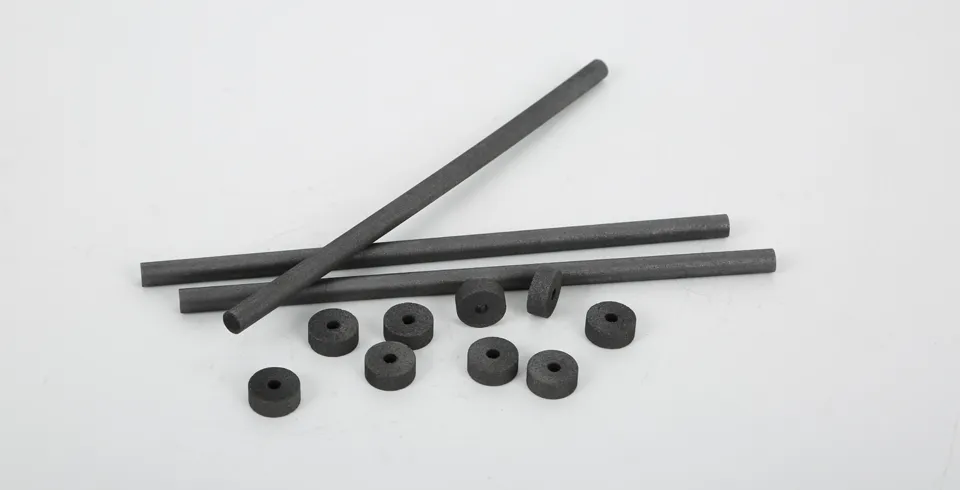 Some graphite disk electrodes and spectral graphite rods are placed on the desk.