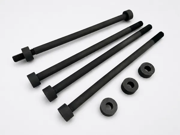 Corrosion resistant vacuum furnace graphite part including bolts and matching nuts.